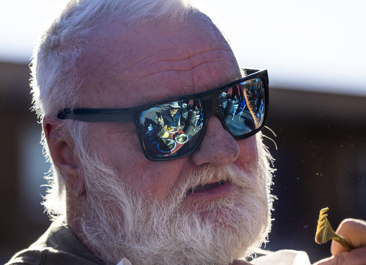 Hebron tenant Dennis Alexander has friend Bill Monroe reflected in his sunglasses as they enjoy ...