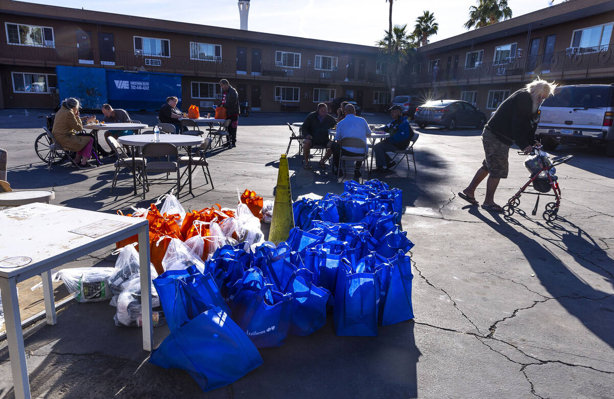 Hebron tenants each receive a gift bag after being served a Thanksgiving meal by community volu ...