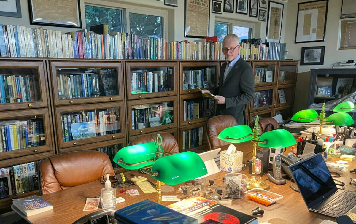 David Marler poses on Nov. 13, 2022, in his Rio Rancho, N.M., home library filled with books an ...