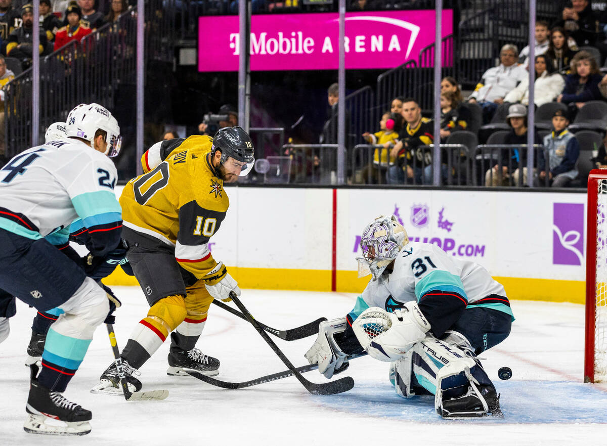 Golden Knights center Nicolas Roy (10) scores between the legs of Seattle Kraken goaltender Phi ...