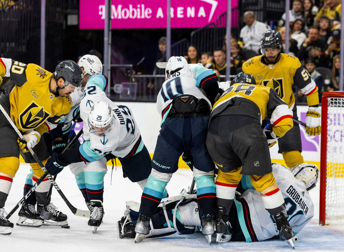 Seattle Kraken goaltender Philipp Grubauer (31) attempts to cover the goal as Seattle Kraken de ...