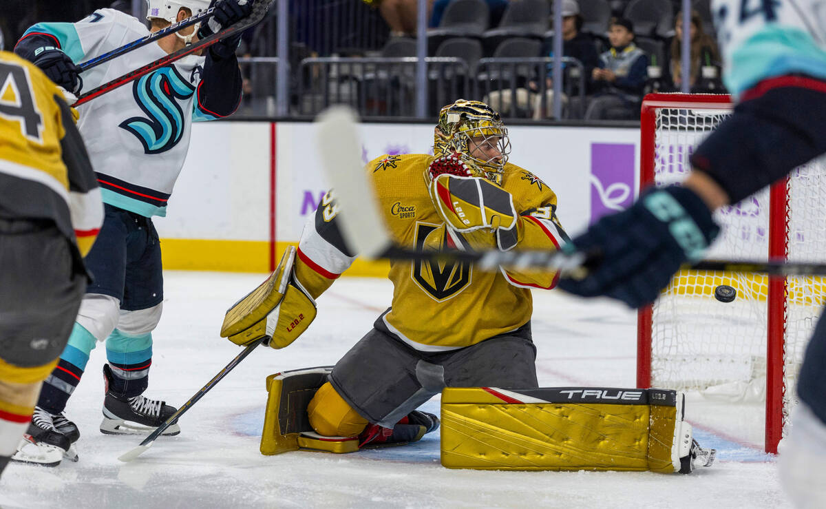 Golden Knights goaltender Adin Hill (33) looks as the puck goes into the net from Seattle Krake ...