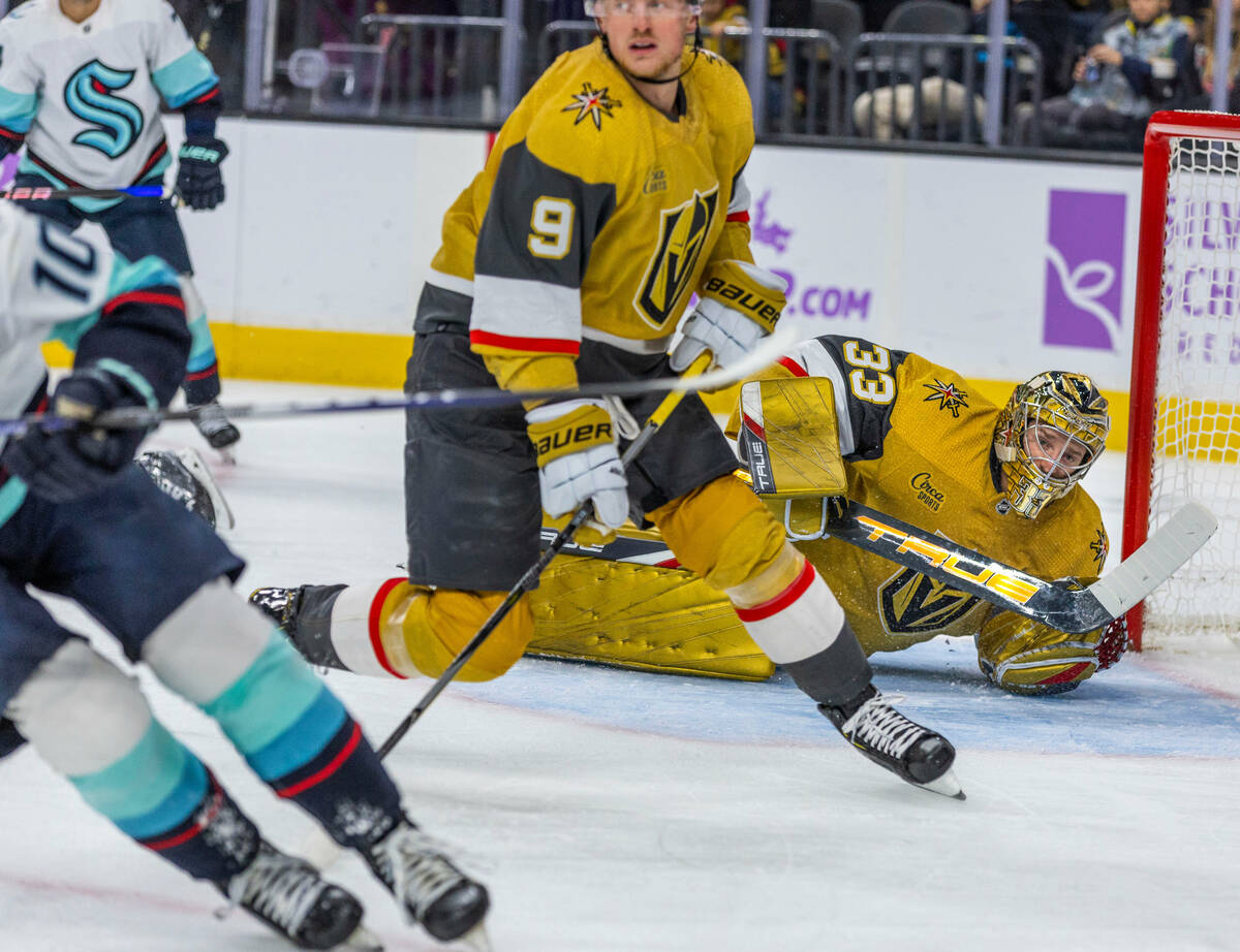 Golden Knights goaltender Adin Hill (33) looks on as the puck is redirected by Seattle Kraken c ...