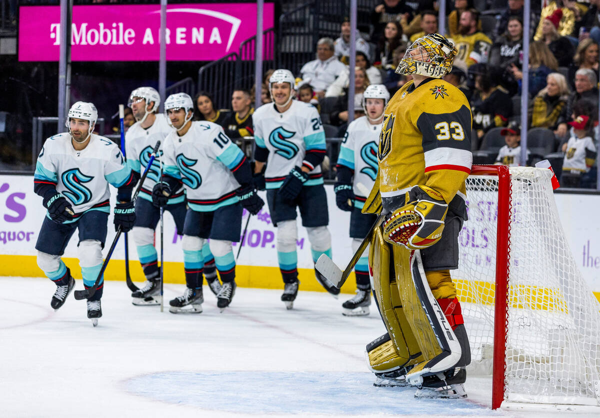 Golden Knights goaltender Adin Hill (33) watches the replay as Seattle Kraken right wing Jordan ...