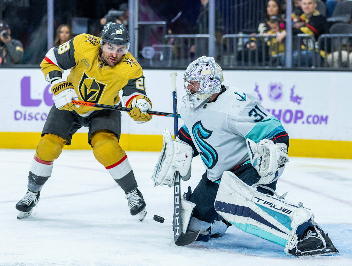 Golden Knights left wing William Carrier (28) deflects a shot towards Seattle Kraken goaltender ...