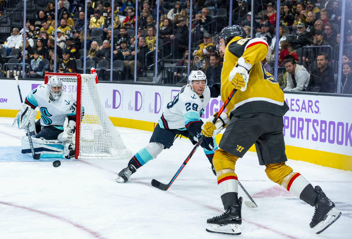 Golden Knights right wing Mark Stone (61) gets off a shot as Seattle Kraken defenseman Vince Du ...