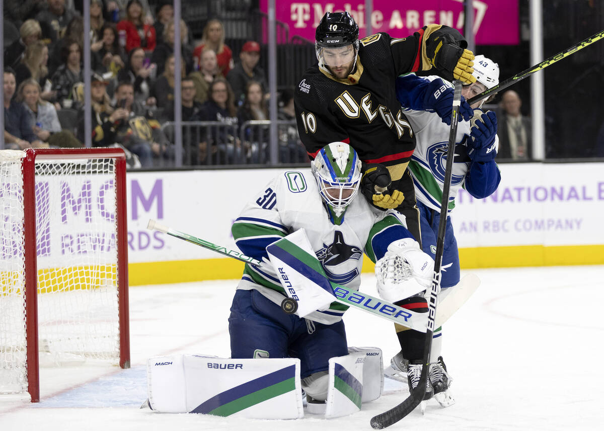 Golden Knights center Nicolas Roy (10) attempts a goal against Canucks goaltender Spencer Marti ...