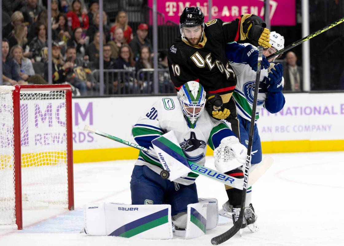 Golden Knights center Nicolas Roy (10) attempts a goal against Canucks goaltender Spencer Marti ...