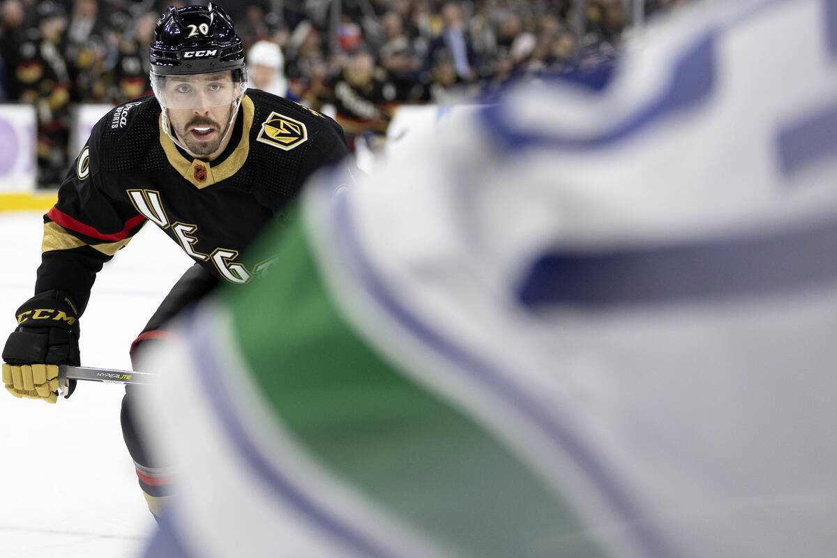 Golden Knights center Chandler Stephenson (20) skates for the puck against Canucks defenseman T ...