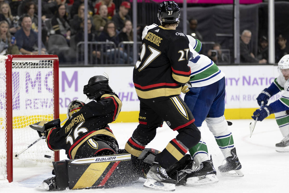 Golden Knights goaltender Logan Thompson (36) misses the save on a goal shot by Canucks center ...