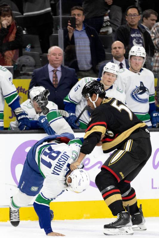 Golden Knights right wing Keegan Kolesar (55) tosses Golden Knights center Jonathan Marchessaul ...