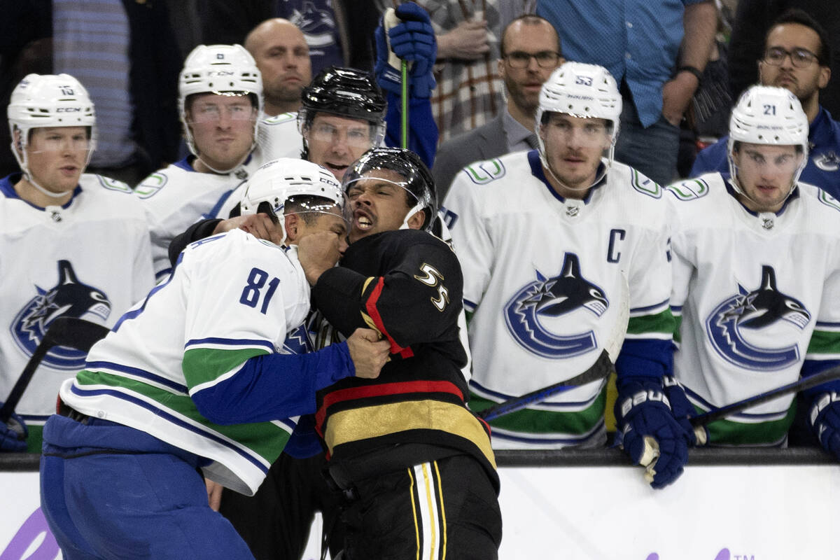 Golden Knights right wing Keegan Kolesar (55) fights with Canucks center Dakota Joshua (81) dur ...