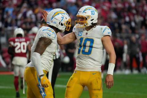 Los Angeles Chargers quarterback Justin Herbert (10) and tight end Gerald Everett (7) celebrate ...
