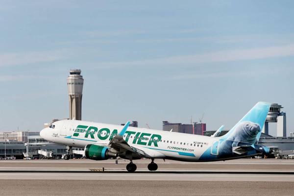 A Frontier Airlines plane lands at the McCarran International Airport in Las Vegas on Thursday, ...