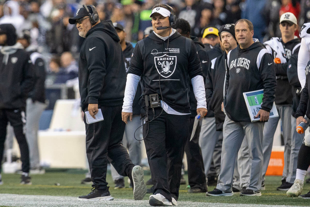Raiders head coach Josh McDaniels walks the sideline during the second half of an NFL game agai ...