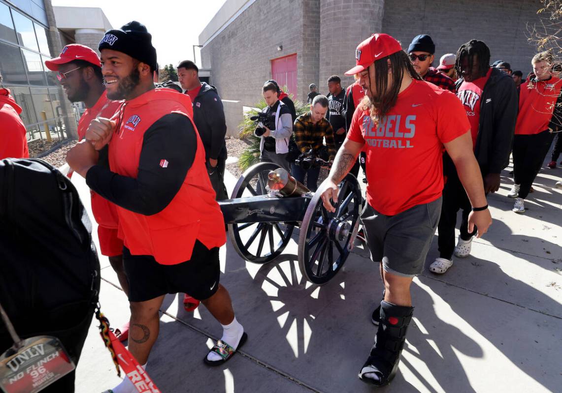 UNLV Football players, including from left, defensive linemen Eliel Ehimare, Tavis Malakius and ...