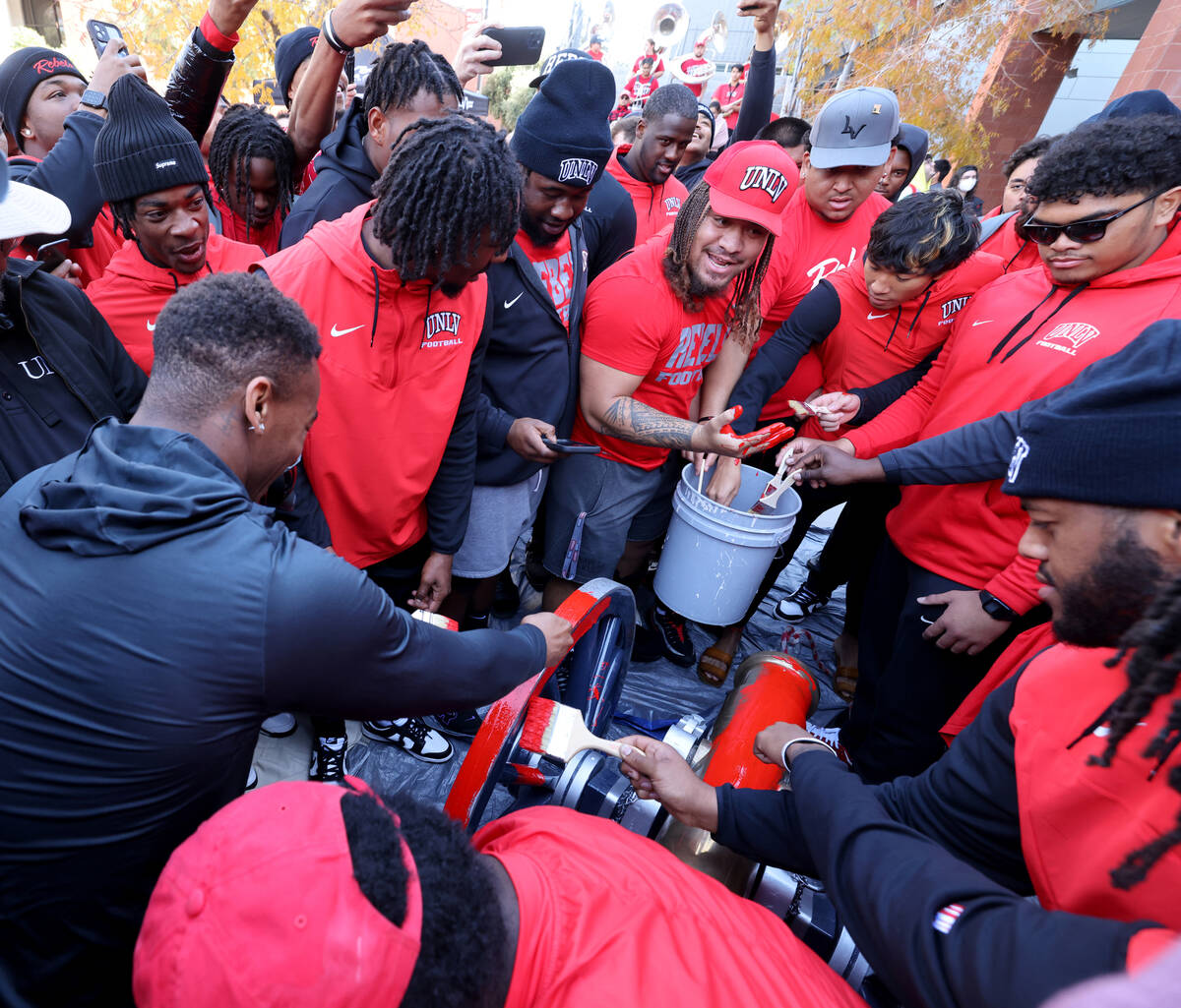 UNLV Football players, including including defensive lineman Naki Fahina, center with paint on ...