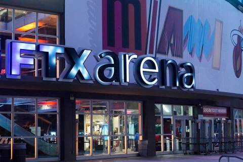 Signage for the FTX Arena, where the Miami Heat basketball team plays, is illuminated Saturday, ...
