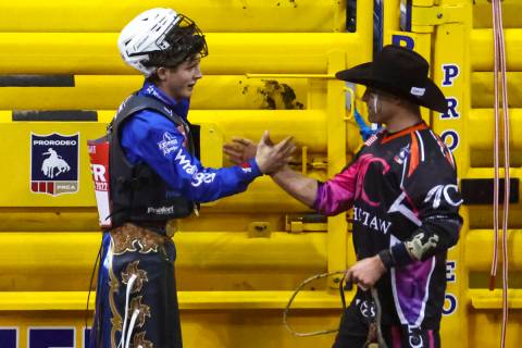 Stetson Wright, of Milford, Utah, left, celebrates after competing in bull riding during the fi ...