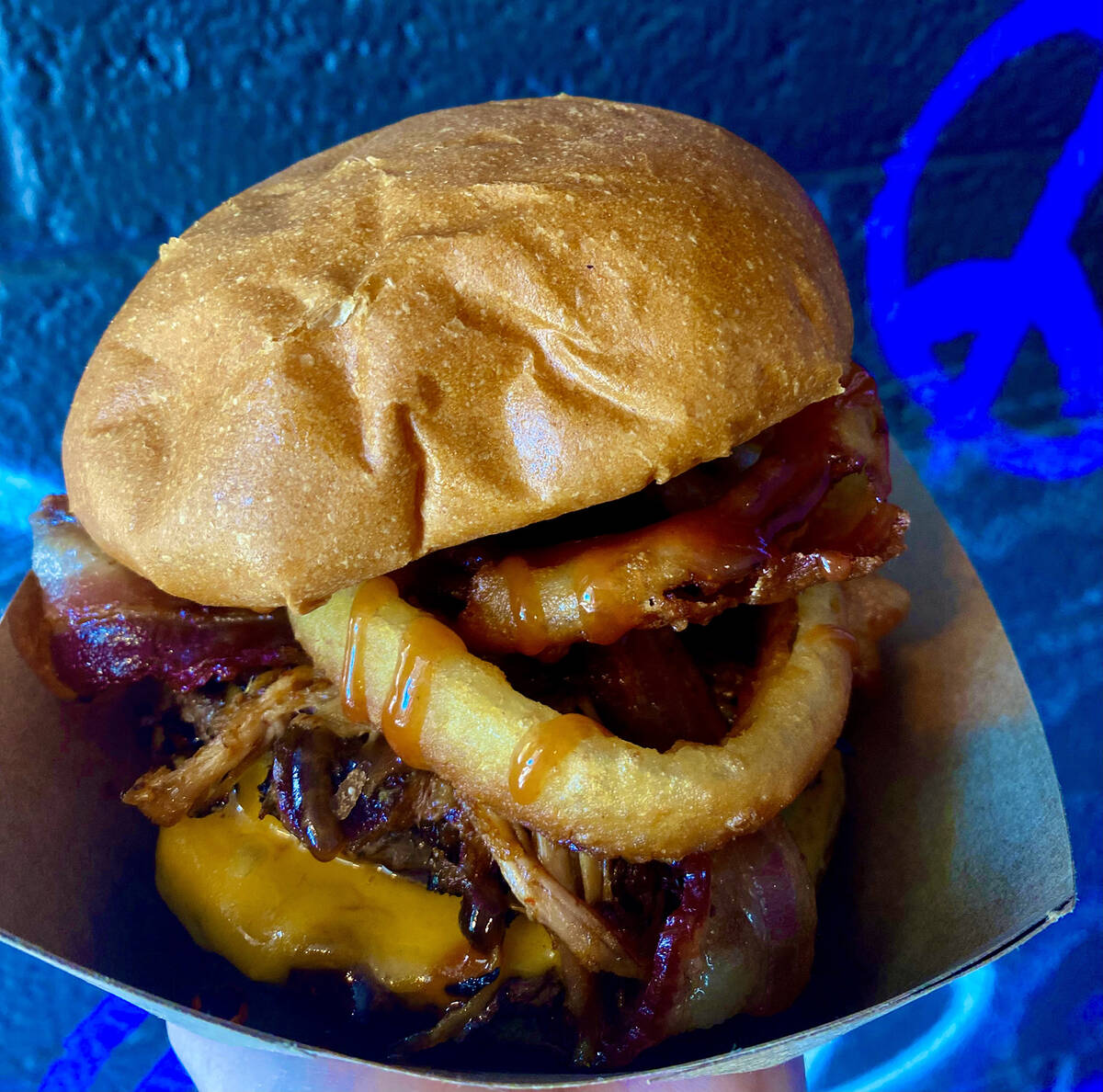A Piggie Smalls burger with pulled pork, fried jalapeños and house barbecue sauce from Str ...