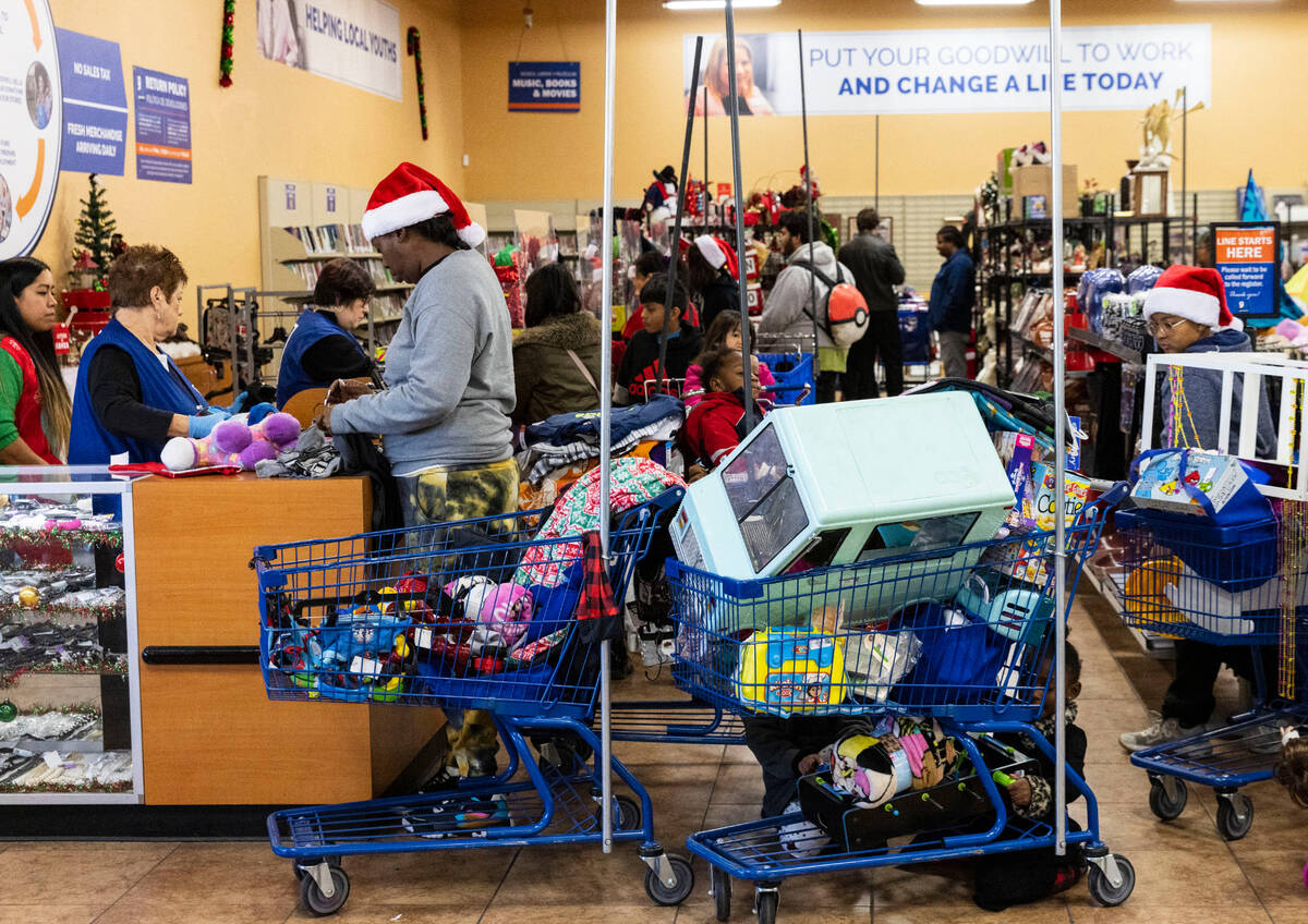 Toumekea Haynie, left, checks out at Goodwill Thrift Store, on Friday, Dec. 2, 2022, in Henders ...
