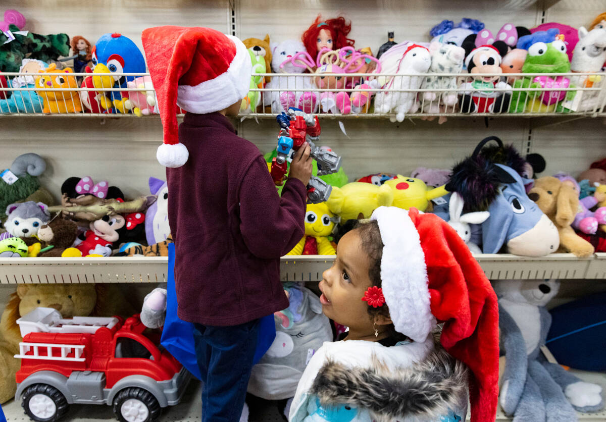 Sophia Wilson, 4, right, and her sister Atina Pagan, 9, shop at Goodwill Thrift Store, on Frida ...