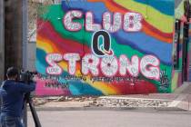 A television cameraman works near a tribute to the victims of a mass shooting at a gay nightclu ...