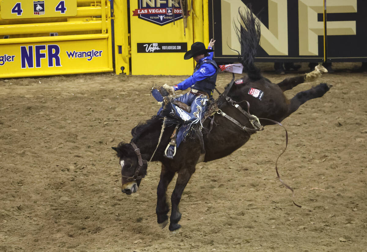 Stetson Wright, of Milford, Utah, competes in saddle bronc riding during the first night of the ...