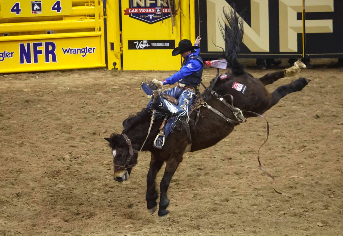 Stetson Wright, of Milford, Utah, competes in saddle bronc riding during the first night of the ...