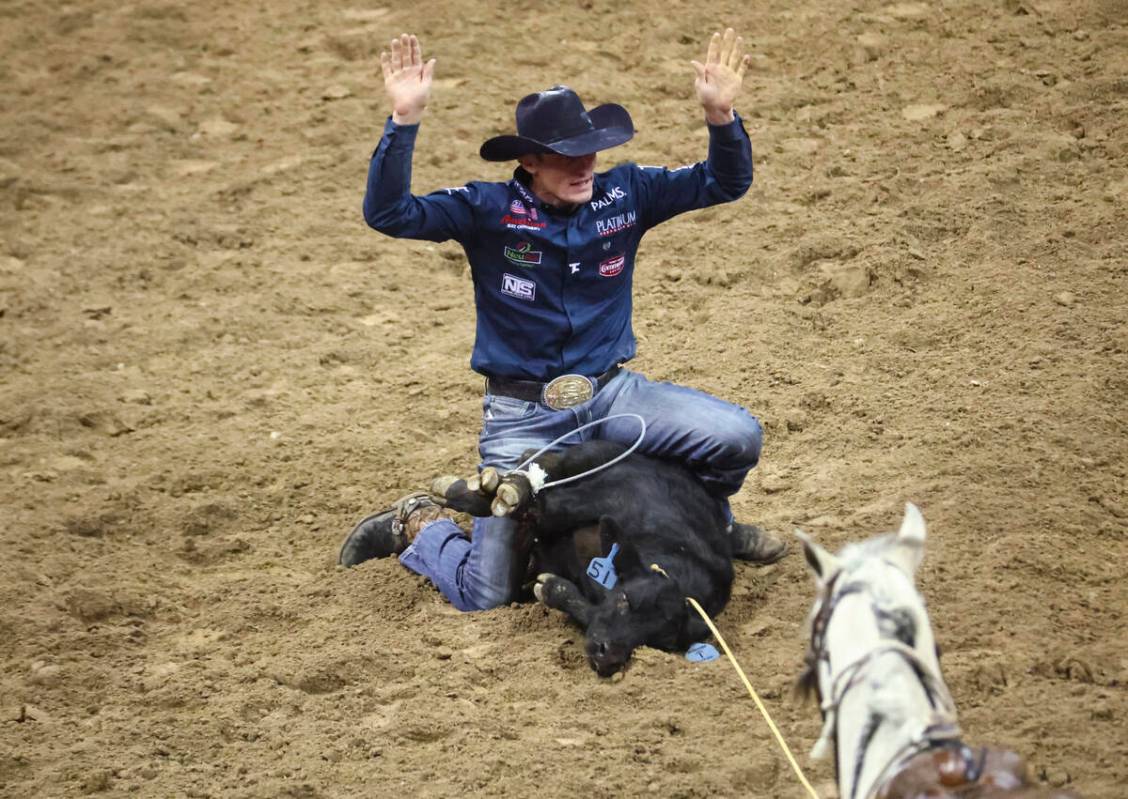 Tuf Cooper, of Decatur, Texas competes in tie-down roping during the first night of the Nationa ...