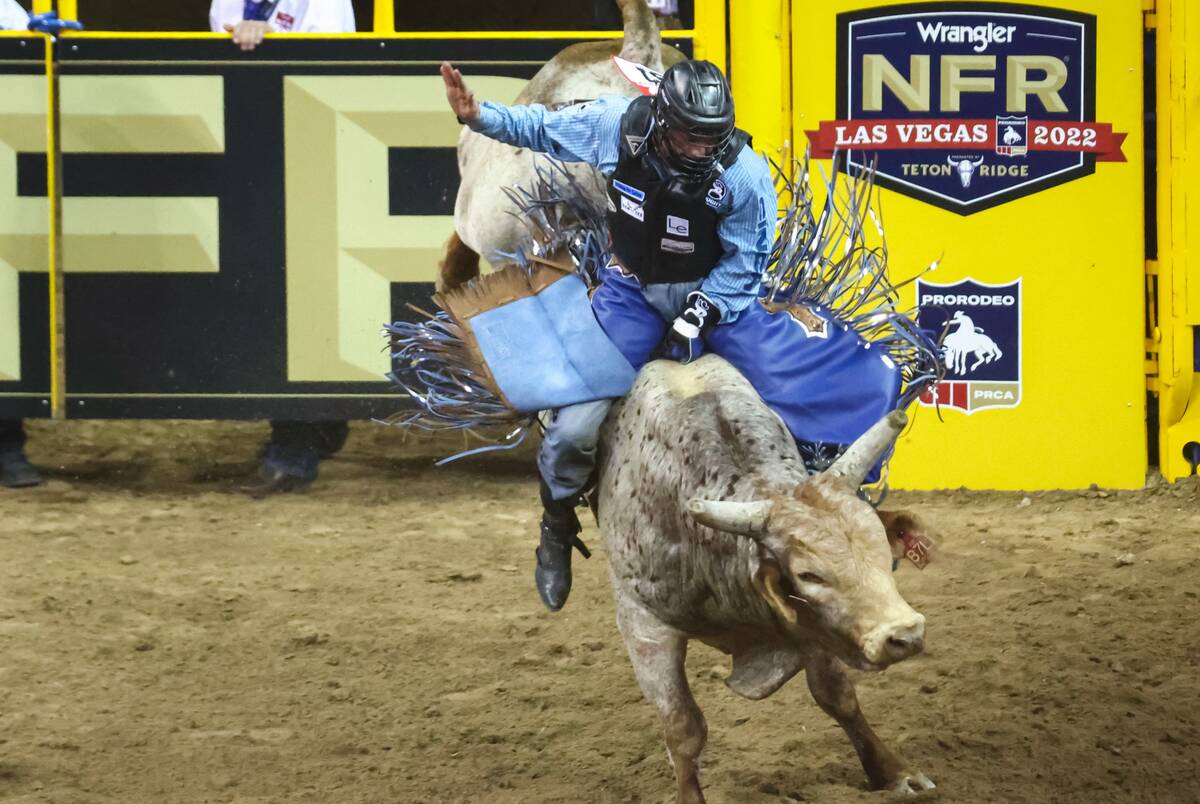 Tristen Hutchings, of Monteview, Idaho, rides Party Animal while competing in bull riding durin ...