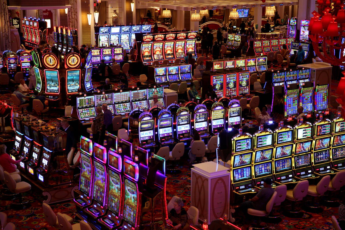 Some of the first guests gamble on the casino floor during the opening of the $2.6 billion Enco ...