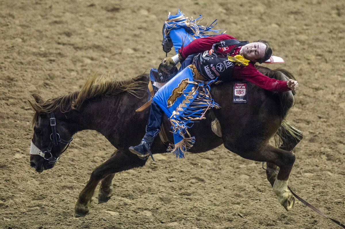 Cole Reiner of Buffalo, Wyo., lays all the way back on his winning ride during Bareback Riding ...