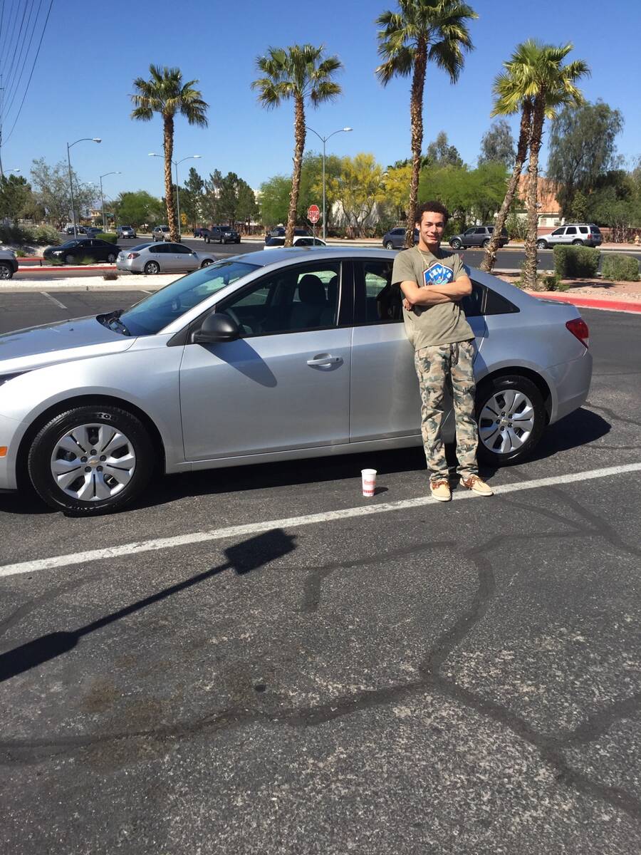 Gianni Corsentino leans against the Chevy Cruze he received as a graduation present from his gr ...