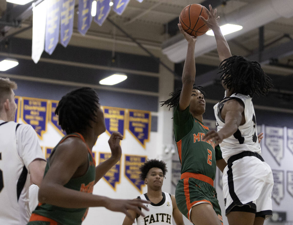 Mojave’s Giali Chapman (2) shoots against Faith Lutheran’s JohnPaul Agu during a ...