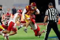 Southern California quarterback Caleb Williams (13) is tackled by Utah safeties R.J. Hubert (11 ...