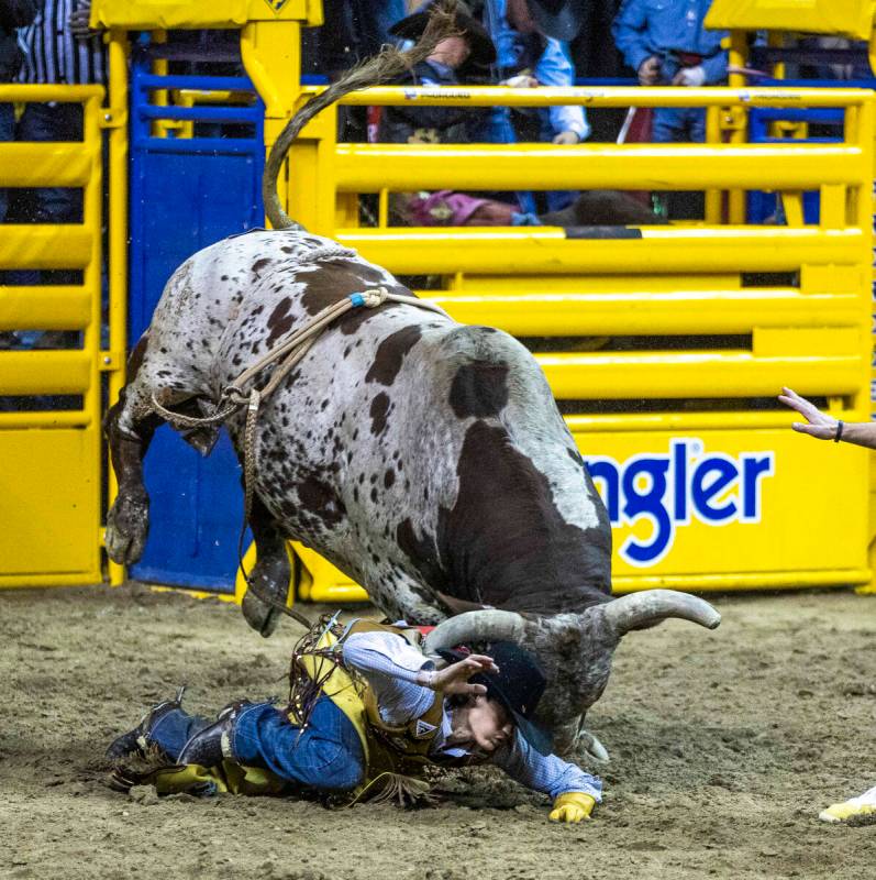 Lukasey Morris of Union City, OK., is driven into the dirt by Preifert's Time Bomb in Bull Ridi ...