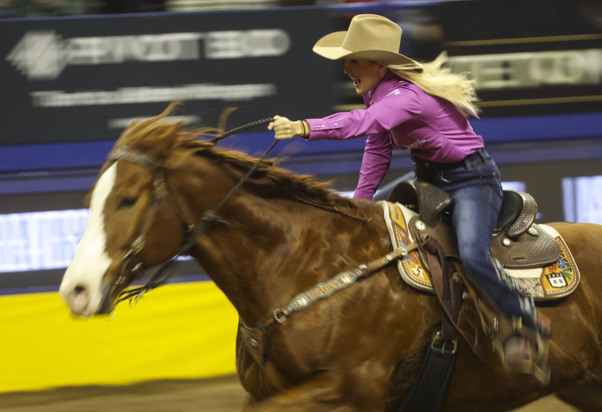 Sissy Winn, of Chapman Ranch, Texas, competes in barrel racing during the fifth go-round of the ...