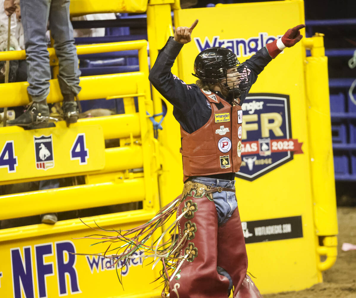 Josh Frost, of Randlett, Utah, celebrates after riding OLSTubs Sunny while competing in bull ri ...