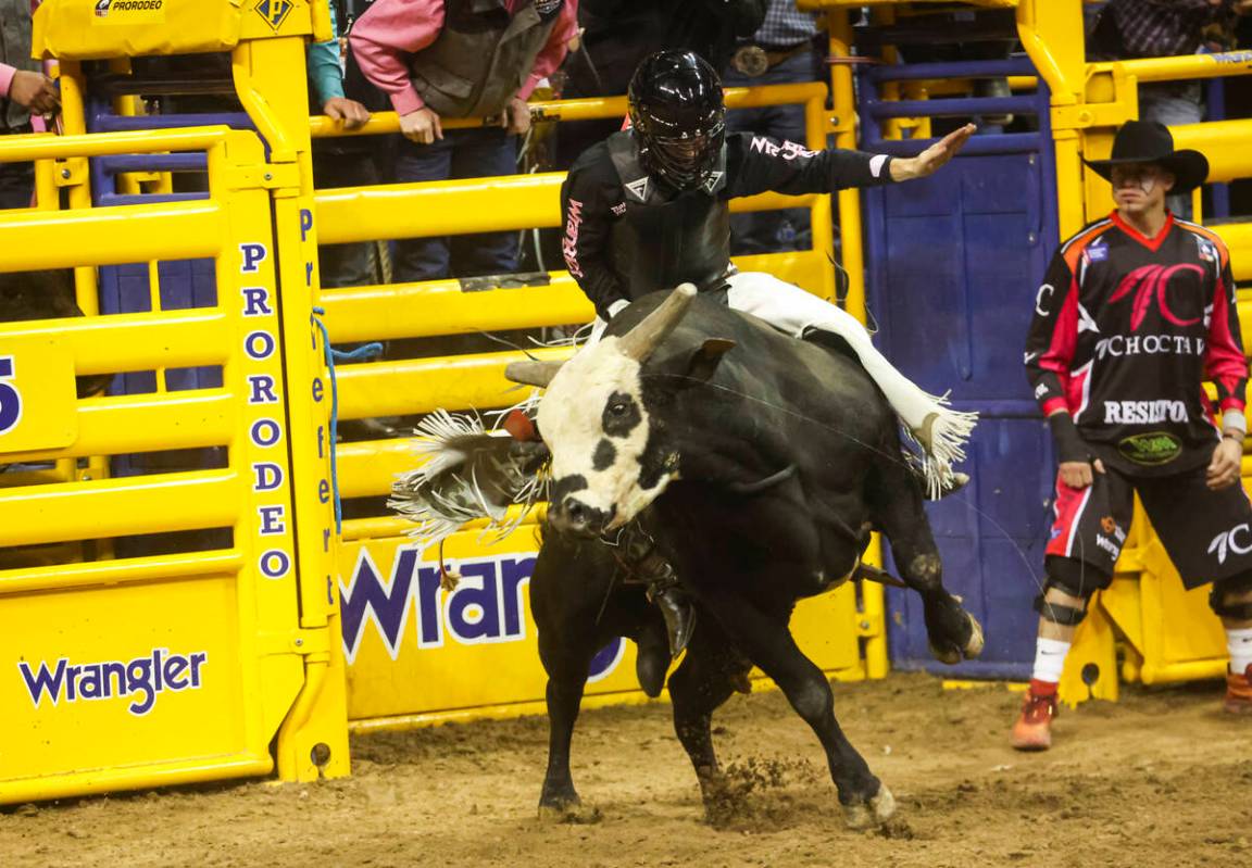 Trey Kimzey, of Strong City, Okla., rides Crash Cart while competing in bull riding during the ...