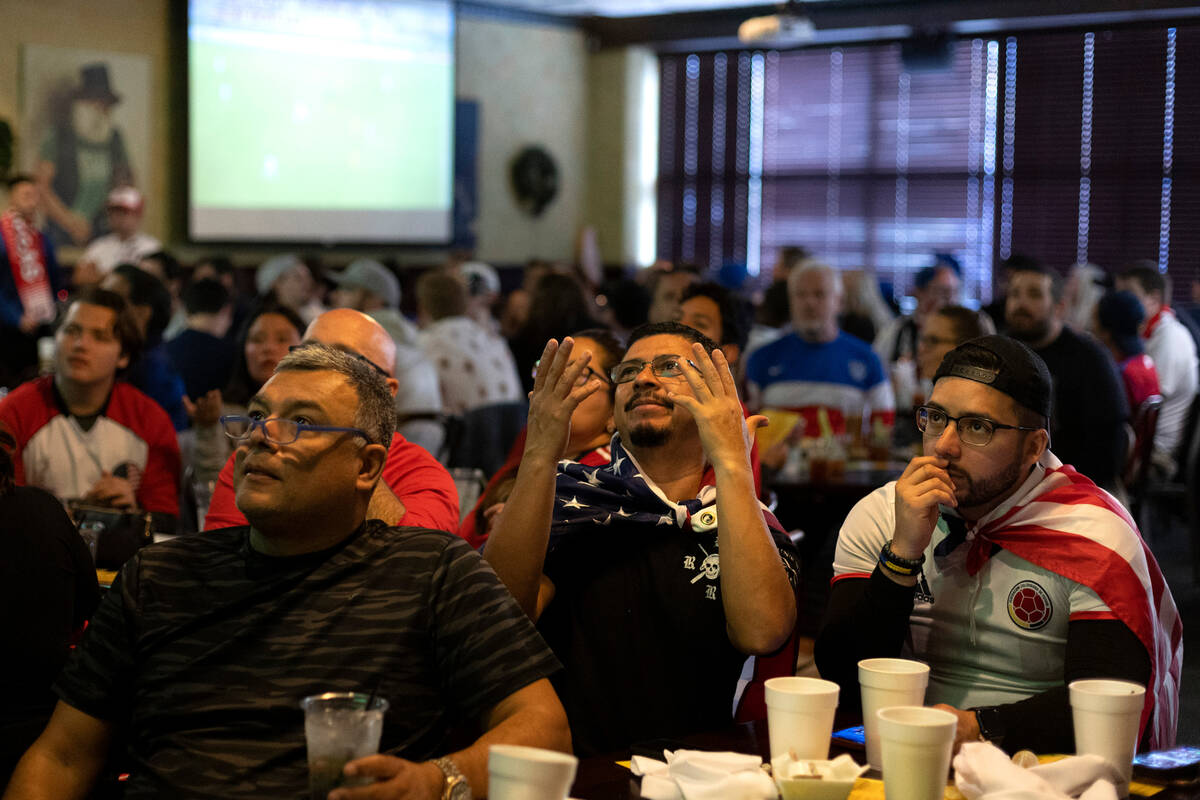 Jesus Chavez, center, and Julio Salazar, right, of Las Vegas, react to the World Cup round of 1 ...