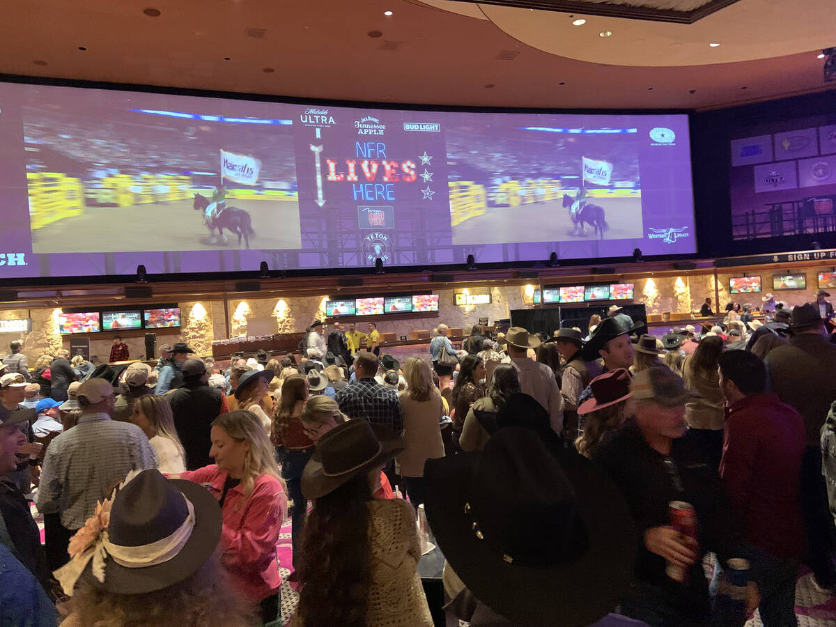 A full house fills out The Mirage sportsbook for Friday night's Wrangler NFR viewing party.