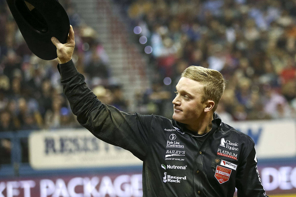 Dakota Eldridge of Elko, Nevada waves at the crowd after taking part in the steer wrestling com ...