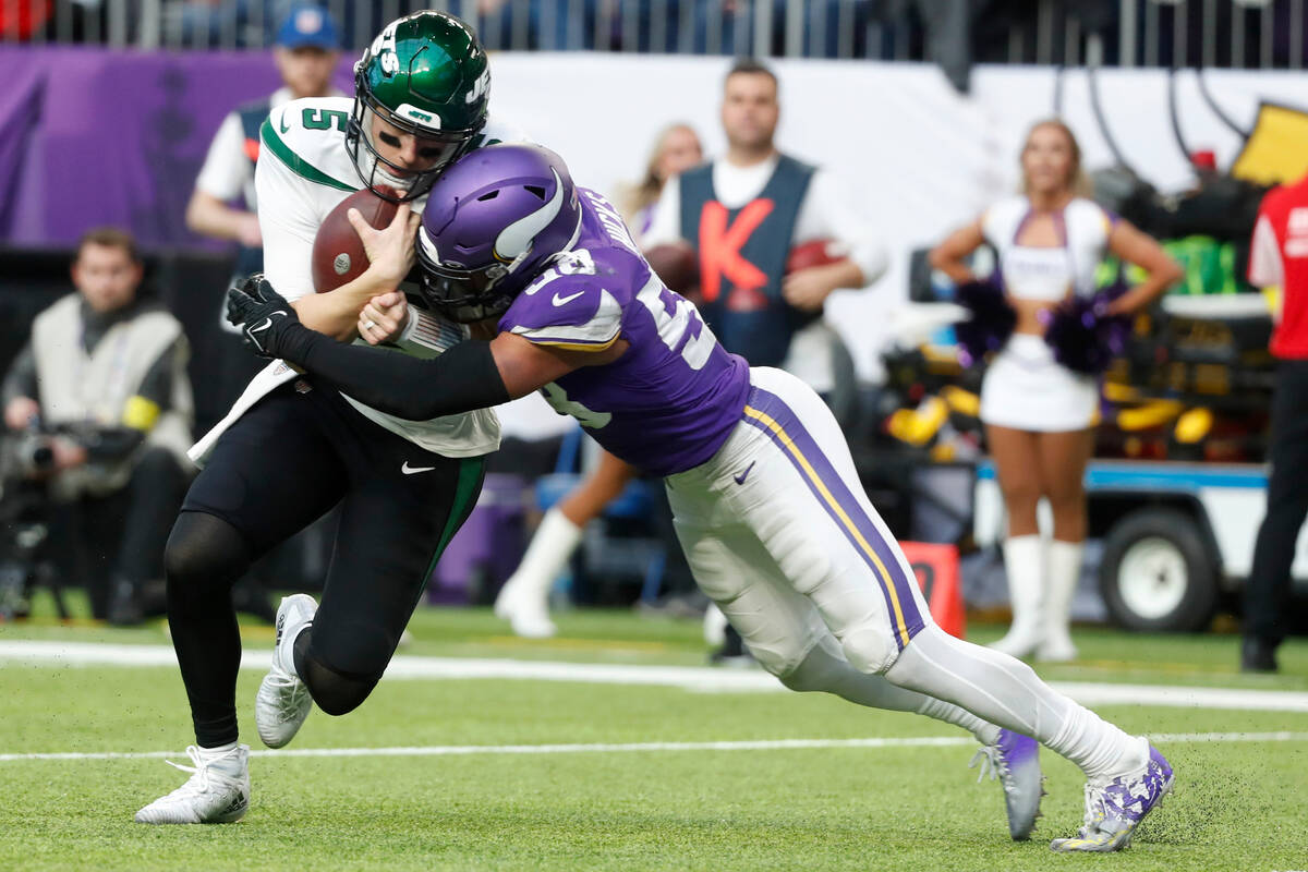 New York Jets quarterback Mike White (5) is tackled by Minnesota Vikings linebacker Jordan Hick ...