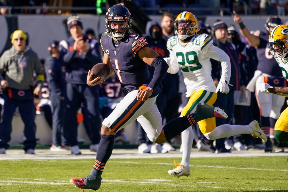 Chicago Bears' Justin Fields runs for a touchdown during the first half of an NFL football game ...