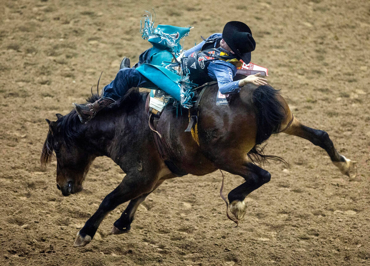 Jess Pope of Waverly, Kan., competes during Bareback Riding in the National Finals Rodeo Day 4 ...