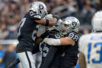 Raiders defensive end Chandler Jones (55) celebrates a sack with Maxx Crosby (98) and Sam Webb ...