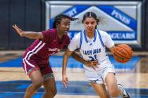 Desert Oasis guard La'Niah Hicks (1) keeps a tight defense on Desert Pines guard Destiny Sao Ma ...