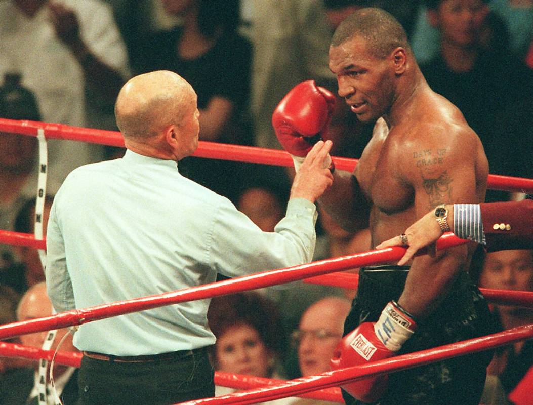 Referee Mills Lane warns boxer Mike Tyson after Tyson bit the ear of opponent Evander Holyfield ...