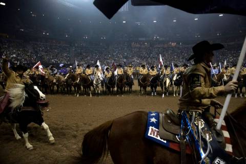 Cowboys and cowgirls take the stage before competing during the sixth go-round of the National ...
